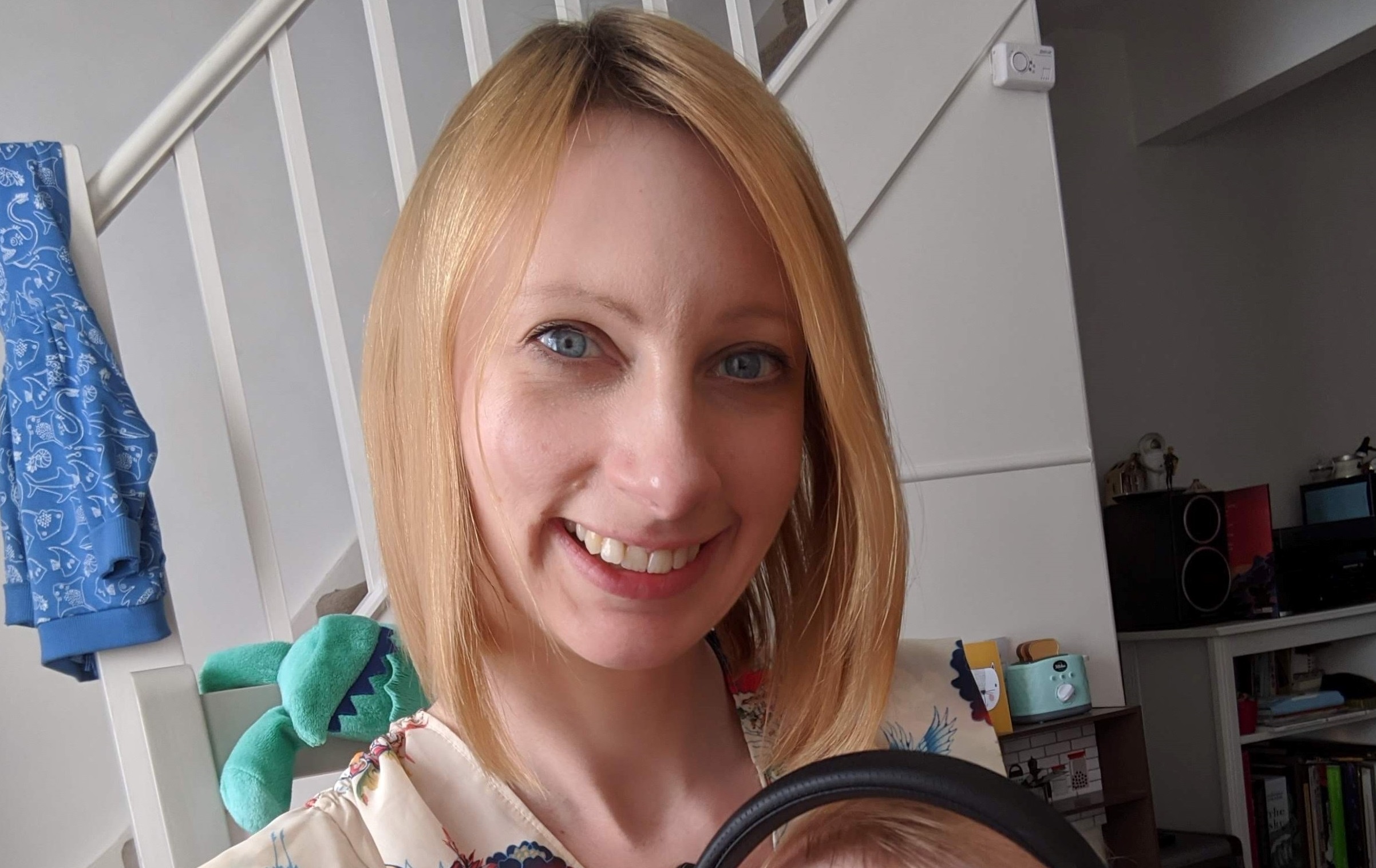 Nicola Lower at home with baby son on her lap