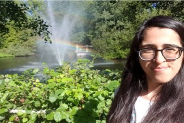 Student Summayah Ahmed poses by the lake on Whiteknights campus