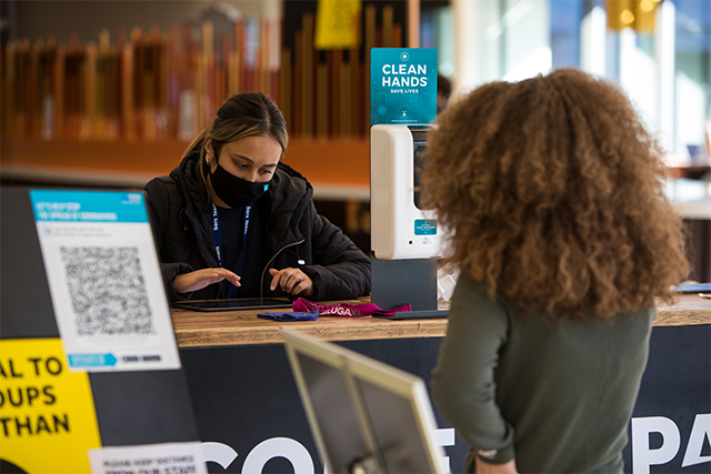 ParkBar staff member wearing a mask using an ipad to register a customer 