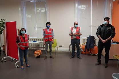 Lecturer Gurinder Singh, fellow alumnus Maj Dal Singh Virdee, and a team of student volunteers pictured in their vaccine center