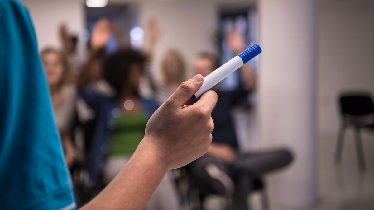 Lecturer pointing with a board marker