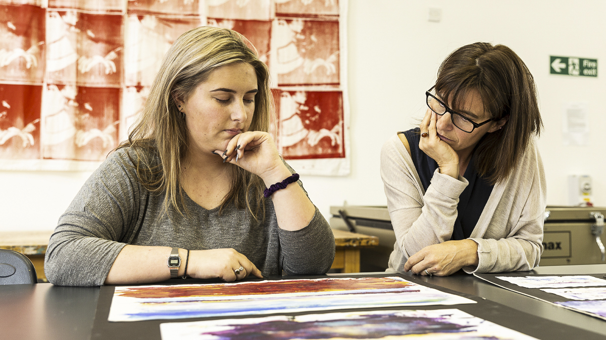 Students reviewing artwork