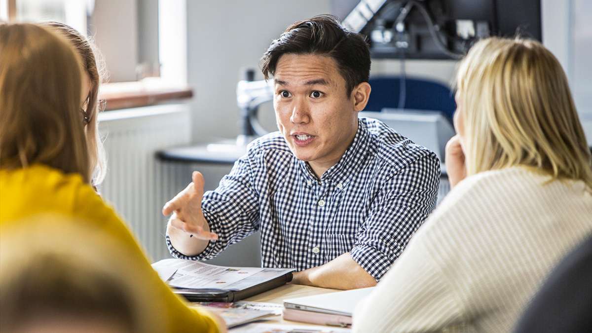 An academic talking to a group of students