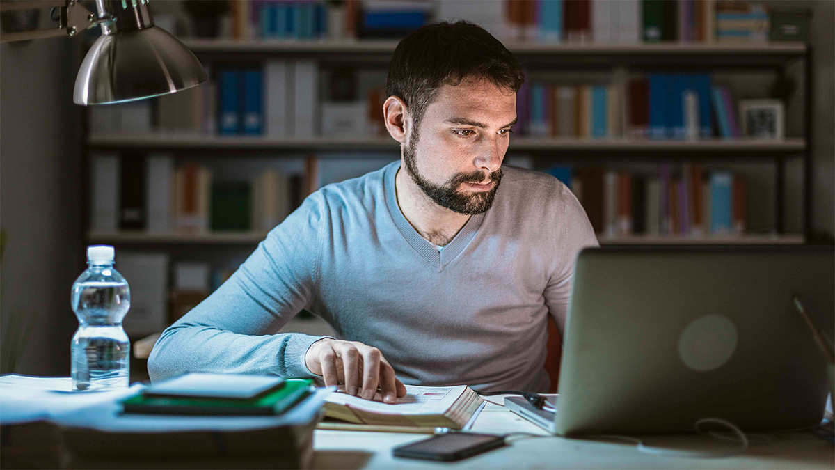 Student working on a laptop in a library