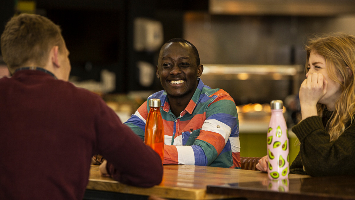 Group of students socialising in a cafe