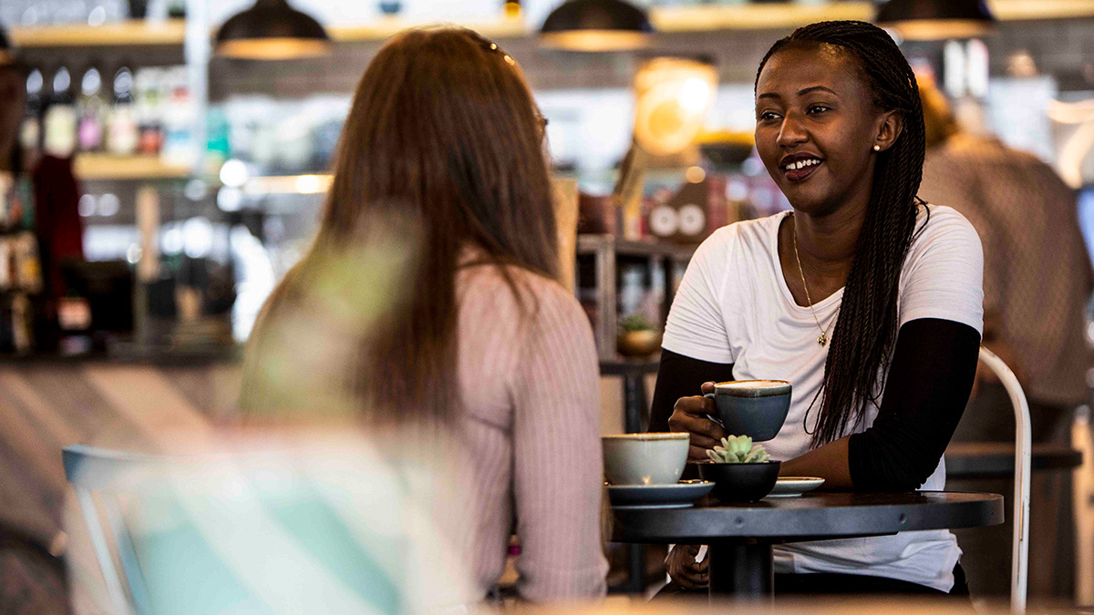 Two students having coffee together in a cafe