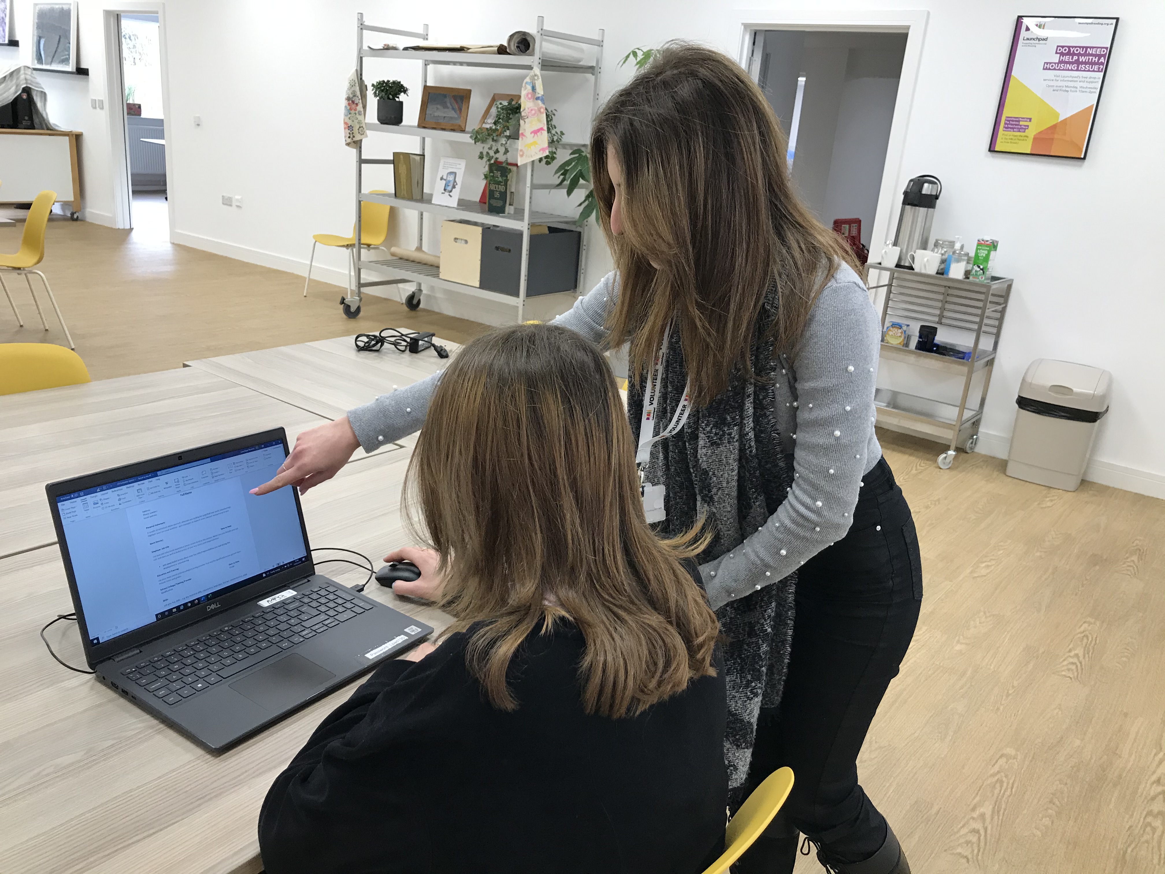 A tutor and Launchpad service user looking at a laptop