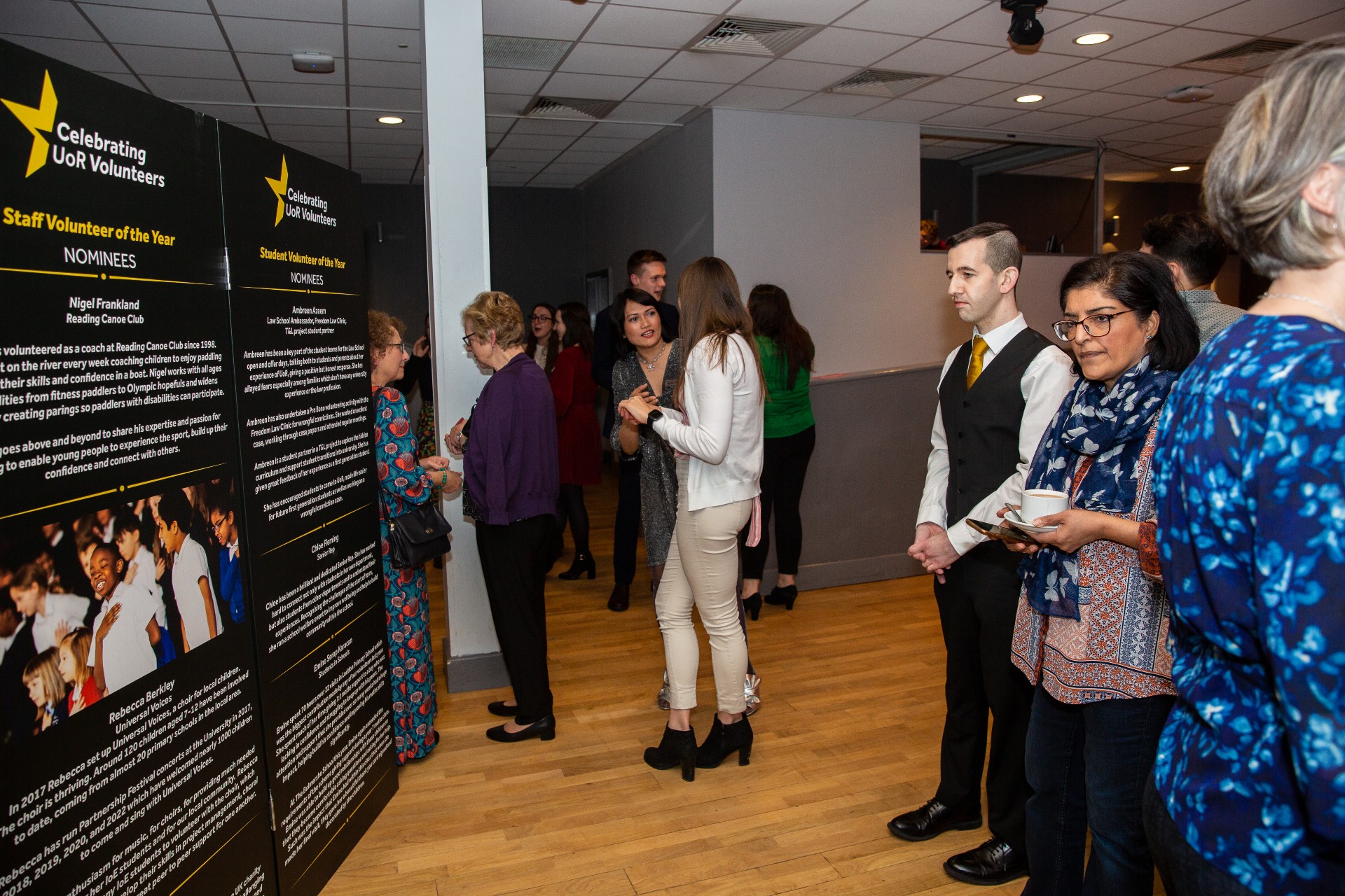 People viewing the Celebration of Volunteering awards exhibition stand