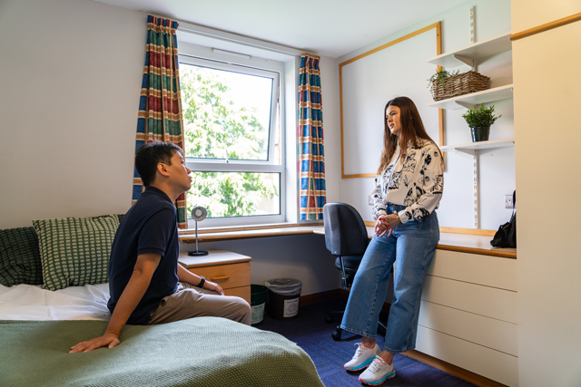 Students talking in a bedroom