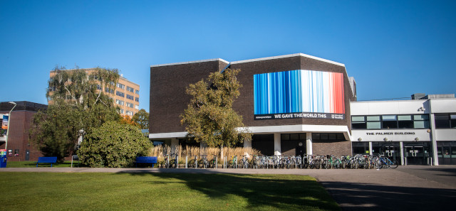 The Palmer Building with an image of the climate stripes
