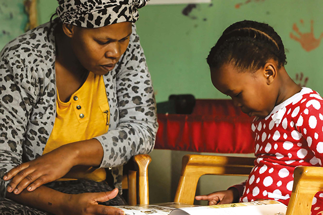 A mother and daughter reading a book together