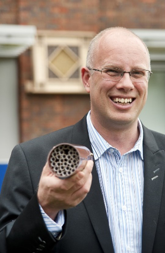 Professor Simon Potts holding a bee hotel